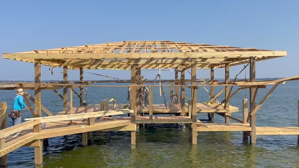 Henderson entertainment boathouse with covered slips, built by Shoretech on Lake Livingston