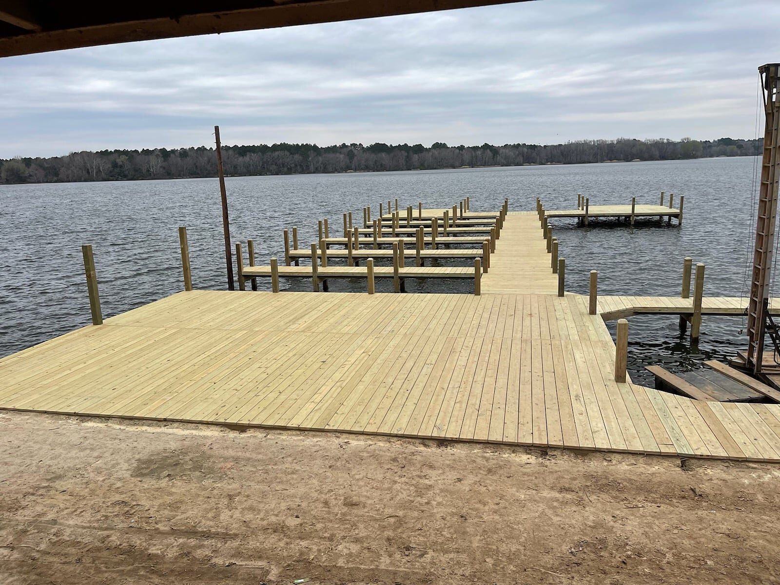 Rebuilt marina at Crockett Family Resort on Houston County Lake — a wide wood deck with rows of open boat slips