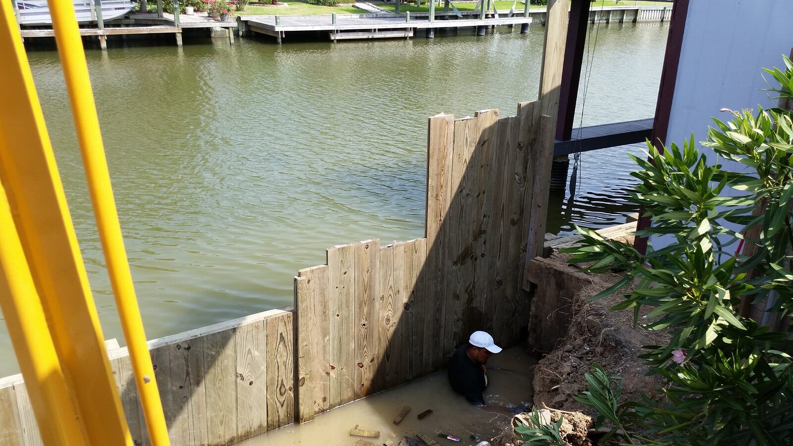 Close-up of a new timber bulkhead wall stepping down to the water along a canal edge