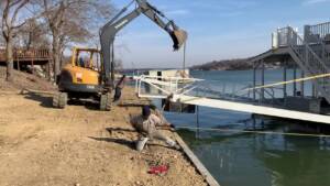Reinstalling the new floating boathouse into the new shoreline bulkhead/seawall.